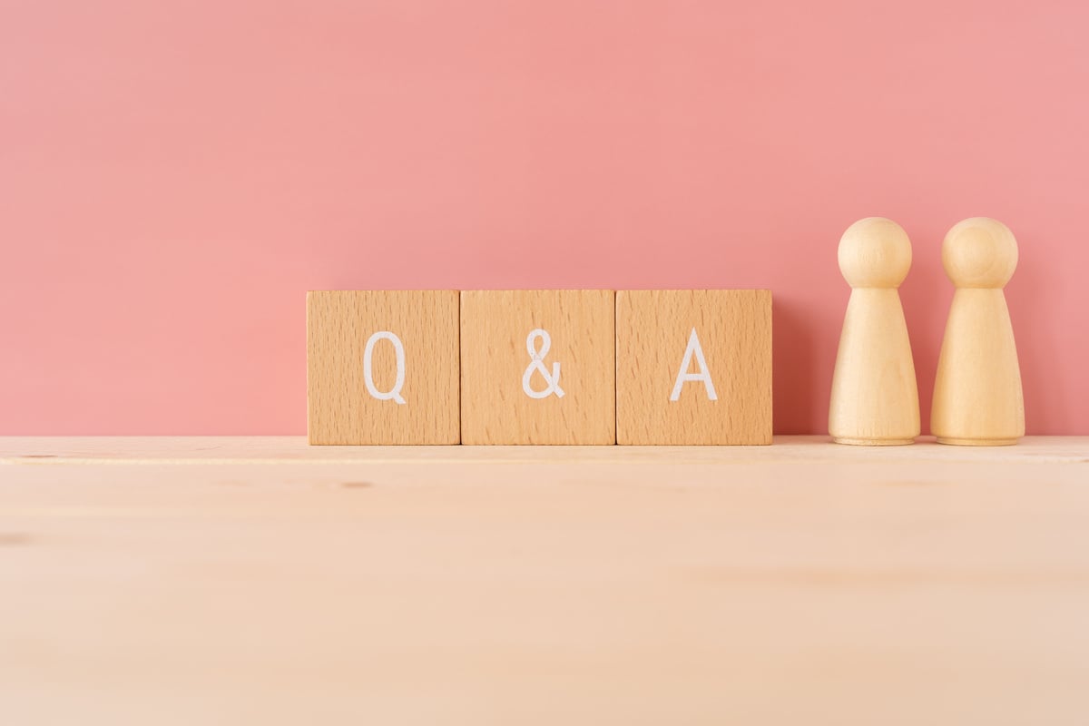 Q and A; Three wooden blocks with "Q and A" text of concept and two wooden toys.